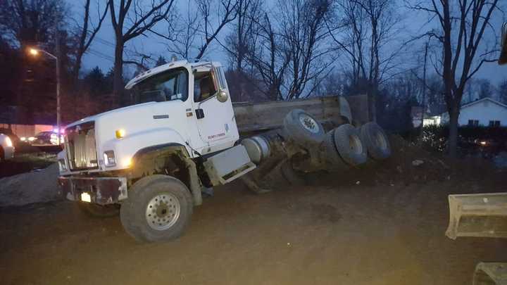 The bed of a dump truck overturned while workers were unloading cargo in New Hempstead.