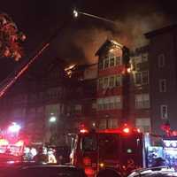 <p>Extensive damage can be seen as the condo building burns on Monday evening in Norwalk.</p>