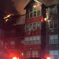 <p>Extensive damage can be seen as the condo building burns on Monday evening in Norwalk.</p>