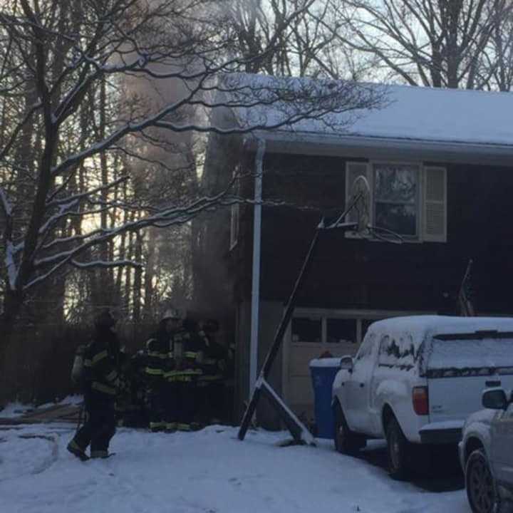 A fire at a home at 70 Osborne Lane in Monroe was contained to the garage on Saturday morning, firefighters said.