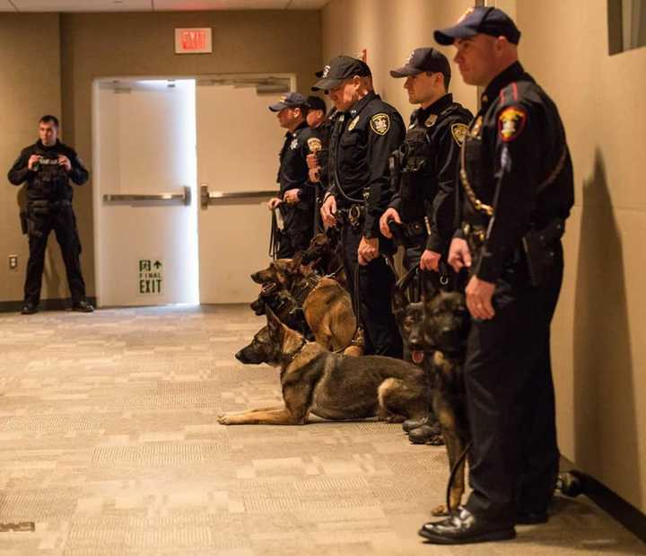 K-9 Officers show off their partners following a training class graduation.