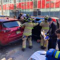 <p>Hoboken firefighters stabilize the vehicle while extricating the mother and daughter.</p>