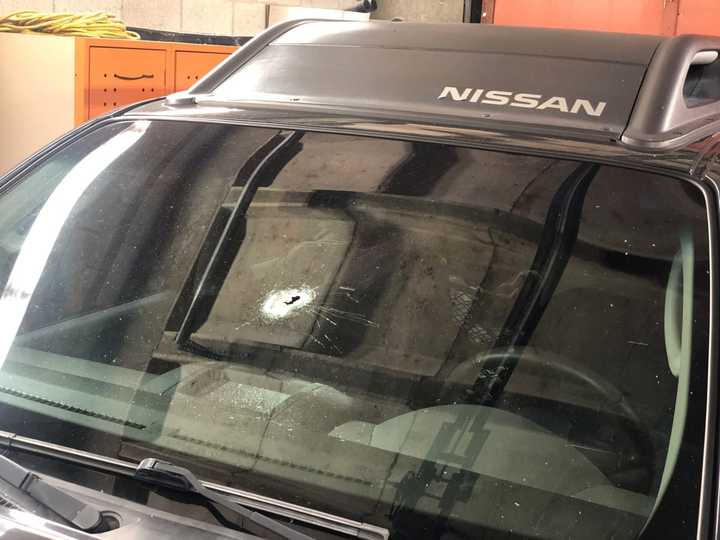 The bullet hole in the officer&#x27;s vehicle.