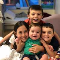 <p>Baby Leland, center, surrounded by his three older siblings.</p>