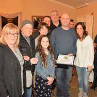 <p>Jason DiSalvo, surrounded by family, shows off his award.</p>