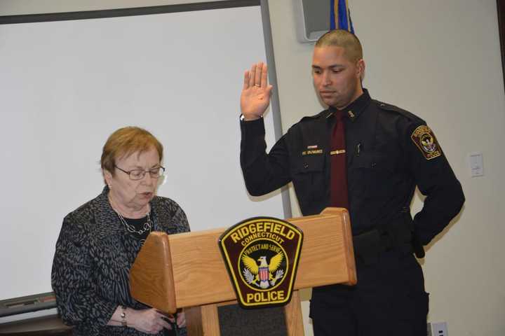 Officer Olivares being sworn in by Town Clerk Barbara Seflilippi