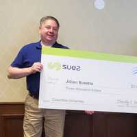 <p>SUEZ’s Tim Michaelson presents a $3,000 SUEZ-NAWC scholarship to Jillian Busetto of Pomona.</p>