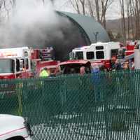 <p>Smoke billows out of the enclosure that held a fully involved dumpster in Mahopac.</p>