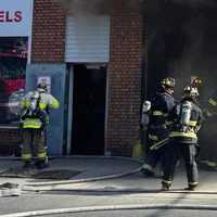 <p>A firefighter was treated for a minor injury in the two-alarm blaze, which went to three bells for manpower.</p>