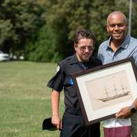 <p>Connor Hayhurst presents the &quot;stolen&quot; artwork back to its rightful owner, Union College President David Harris.</p>