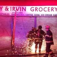 <p>Firefighters gain entry to Neury &amp; Irvin Grocery at Hamilton and Madison avenues in Passaic.</p>