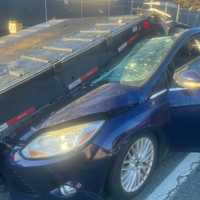 <p>The car landed under a rollback truck in Joppa</p>