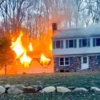 <p>The fire erupted in the attached garage of the home on Rambling Brook Road in Upper Saddle River.</p>