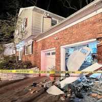 <p>Oradell firefighters made sure the house on Schlomann Drive was safe before the sedan was towed.</p>