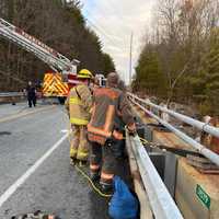 <p>A woman who fell 25 feet from a bridge in Torrington was rescued by firefighters.</p>