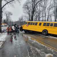 <p>Crews work to clear a school bus that overturned on County Route 111 in Pittstown Friday morning, Jan. 20.</p>