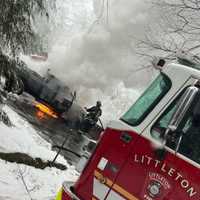 <p>A Littleton fire truck in front of the burning truck.</p>