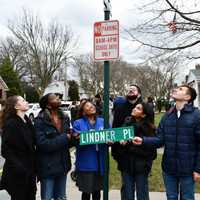 <p>Community members admire the newly renamed Acorn Way during a ceremony held outside Maurice Downing Elementary School on Thursday, Jan. 26.</p>