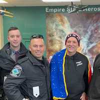 <p>Jimmy Thomas, age 61, of Ballston Spa, poses with police Saturday, Feb. 4, after kayaking to Florida and biking back to New York to raise money for veterans in need of service dogs.</p>