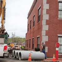 Man Injured When Backhoe Knocks Lamppost Into Hackensack Law Office Window