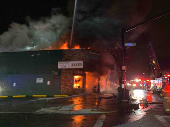 A three-alarm fire tears through a business at 90 Essex Street in Lawrence