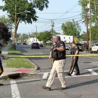 <p>Police cordon off the street moments after gunfire erupted outside Carver Park in Hackensack.</p>