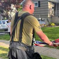 <p>A firefighter and borough police officer folded a burned American flag that had been flying in front of the home.</p>