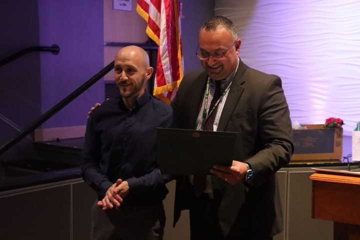 Custodian Craig Nelson (left) is honored at a Yorktown Board of Education meeting for saving the life of a choking child at Mohansic Elementary School.