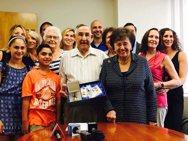 Alfred Magnatta receives his medals from Congresswoman Nita Lowey.