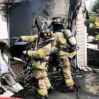 <p>Neighbors brought Mahwah firefighters and members of other area companies who assisted them water bottles to help keep them hydrated.</p>