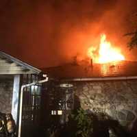 <p>Firefighters work to put out a fire that killed one person.</p>