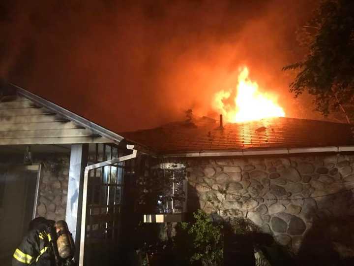 Firefighters work to put out a fire that killed one person.