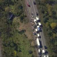 <p>The scene of the crash with the bus in the wooded area in the middle.</p>