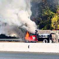 <p>Franklin Lakes firefighters douse a dump truck blaze the morning of Thursday, Oct. 26.</p>