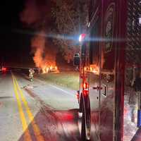 <p>The scene of the deer lying dead in the road and the car that struck it completely engulfed in flames as crews battle the blaze.&nbsp;</p>