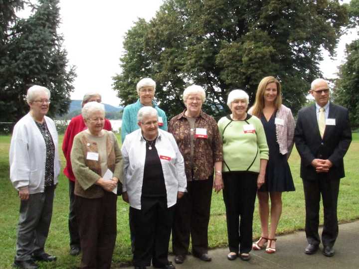 A group of the Dominican Sisters of Hope stand outside on the preserved land along the Hudson River.