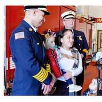 <p>Heroes Mike Greco and Rob Knoblock with Vanessa Senquis and her two children.</p>