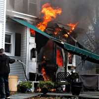 <p>A passerby grabbed a garden hose and tried to douse the fire at 19 Liberty Street in Ridgewood without much luck.</p>