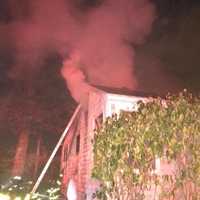 <p>Four family members escaped a fire that started in the ceiling of their Norwalk home.</p>