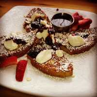 <p>Irish soda bread french toast with sour cream and a warm raspberry drizzle.</p>