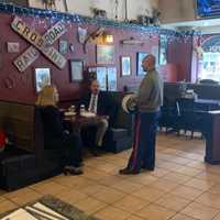 <p>A U.S. Marine who recently relocated to the area had his lunch paid for by Rutherford councilwoman Stephanie McGowan, pictured here talking to him with her colleague from Felician University.</p>