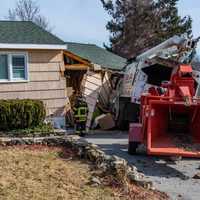 <p>A truck rolled into a house while working on trees in the area.</p>