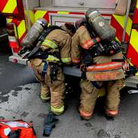 <p>Milford firefighters work to save six bunnies overcome by smoke in the fire.</p>