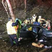 <p>Rescuers from several fire departments worked to free a woman trapped inside a vehicle.</p>