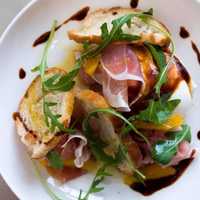 <p>Prosciutto, toasty Italian bread, Asiago cheese, burrata, arugula, balsamic vinegar and fragrant olive oil.</p>