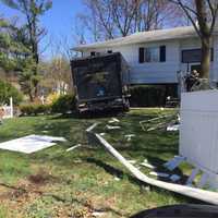 <p>A large moving truck plowed into the front of a home.</p>