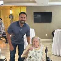 <p>Paramus Mayor, Christopher DiPiazza presents Rosemarie with a Certificate of Commendation in honor of her birthday.</p>