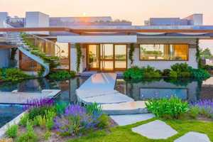 $26M 'Breathtaking' Mass Beachfront Mansion Comes With Waterfall, Sauna, Rooftop Infinity Pool