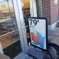 <p>The sedan pushed a sign up against the entrance, shattering a glass door.</p>