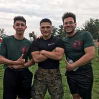 <p>Garcia, far right, with U.S. Marine Armando Nava and peer Stanley from Hackensack High School.</p>